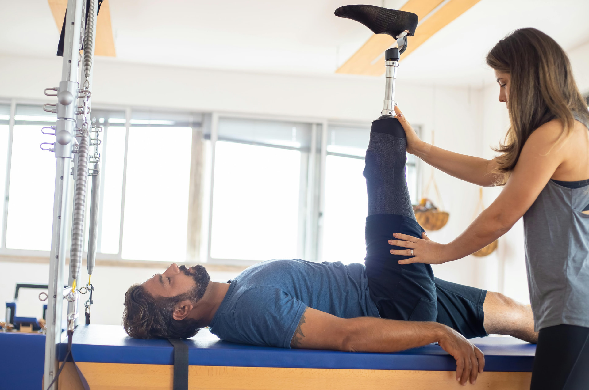 Therapist guiding a patient through table-based rehabilitation exercises