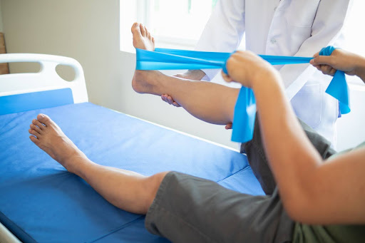 Therapist guiding a patient through resistance band exercises at PursuitPT